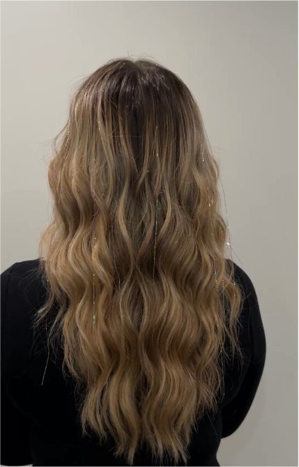 Wavy blonde hair with subtle fairy hair tinsel throughout