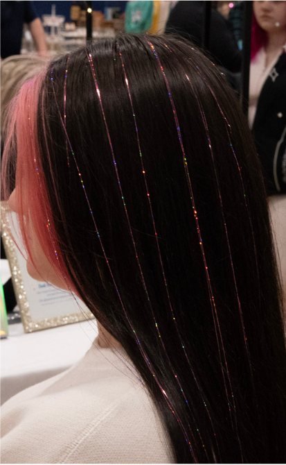 Long dark hair with shimmering pink and rainbow hair tinsel strands
